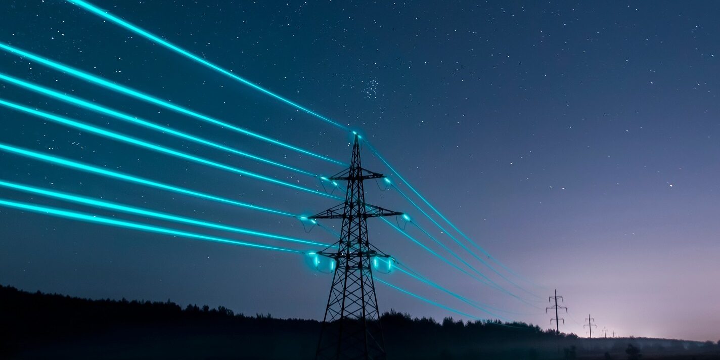 Electricity,Transmission,Towers,With,Glowing,Wires,Against,The,Starry,Sky. Electricity,Transmission,Towers,With,Glowing,Wires,Against,The,Starry,Sky.